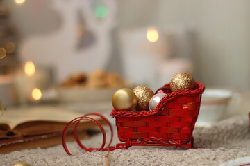 Bowl of cookies, cup of tea, dry oranges, pine cones, books, reading glasses, small presents,...