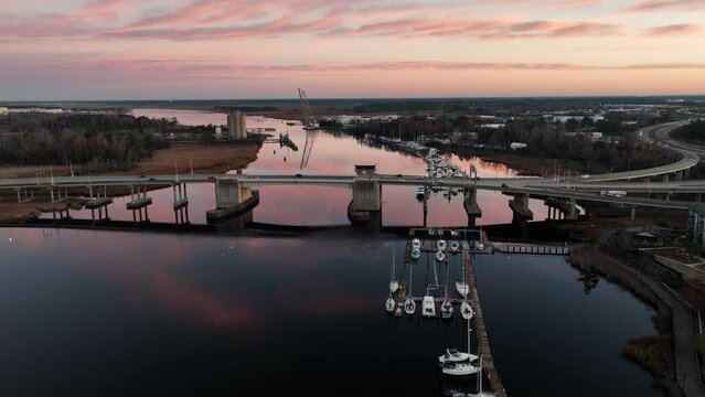 Cape Fear River with the Isabel Holmes Bridge in the back during a sunrise. 