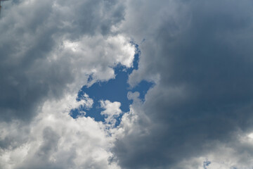 A gap in the clouds through which the blue sky is visible