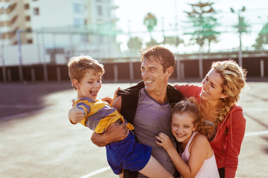 Happy Young Family Enjoying Sunny Day Outside