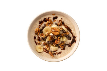Oats with dry fruits. Breakfast with healthy oats banana and dry fruits. Oatmeal with dried fruits in white bowl