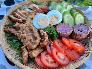 Crispy fried soft shell crab, baked chicken breast with boiled egg and vegetable salad