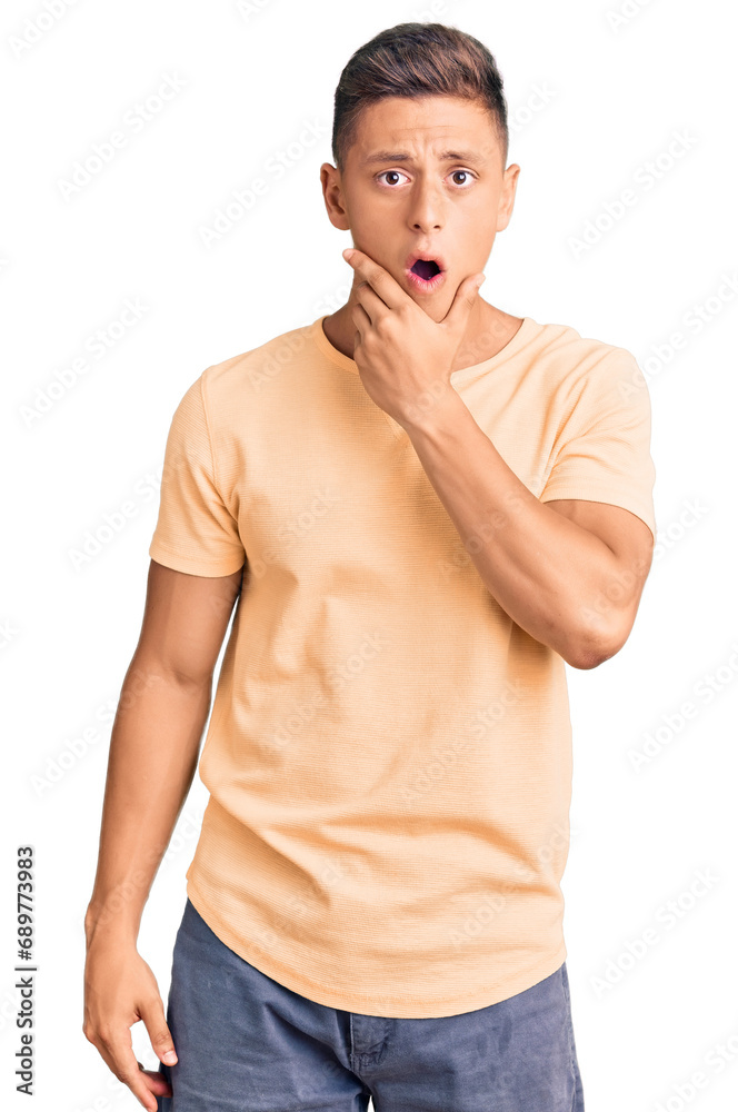 Canvas Prints Young handsome man wearing casual clothes looking fascinated with disbelief, surprise and amazed expression with hands on chin