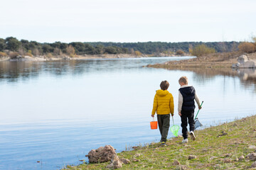 children together in nature. Children walking by a lake