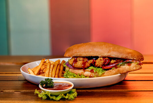 Big hamburger with french fries and ketchup on a wooden table