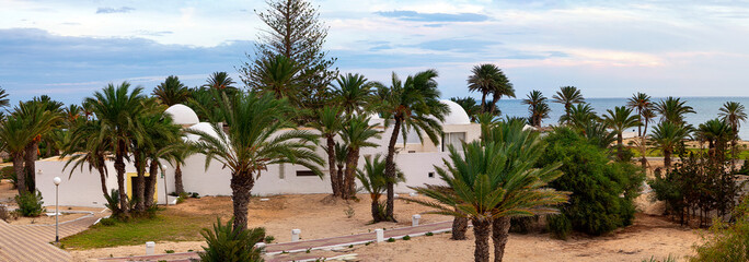 Resort landscape with palm trees and hotels on the Mediterranean coast. Tunisia. Jerba Island. Panorama.