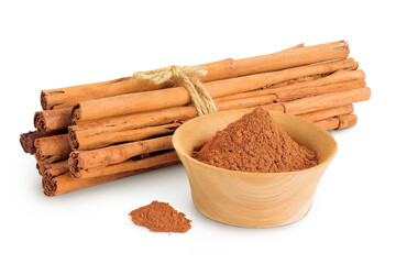 Cinnamon sticks with powder in wooden bowl isolated on white background with full depth of field