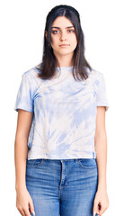 Young beautiful girl wearing casual t shirt relaxed with serious expression on face. simple and natural looking at the camera.
