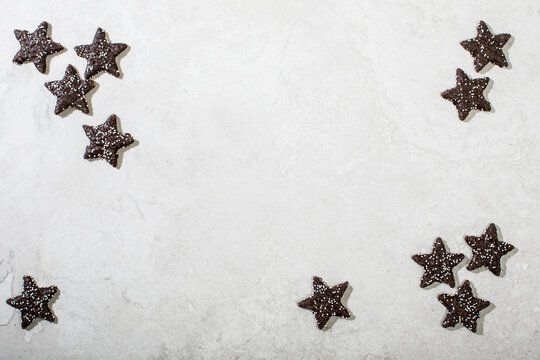 Chocolate star cookies on white surface