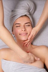 Young woman receiving back massage at spa salon. Beauty treatment concept.
