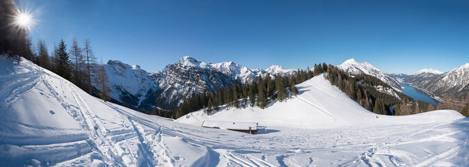 ski piste karwendel alps in winter, with snow tracks and view to lake Achensee, tyrol