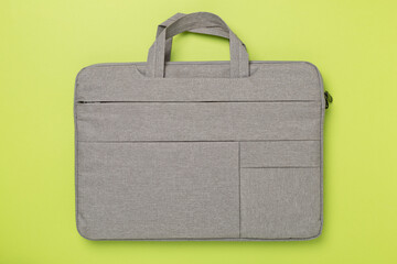 Grey stylish laptop bag on color background,top view