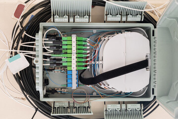 Fiber Optical cables connected to high-speed ports.  a hub box for connecting house cables to fast...