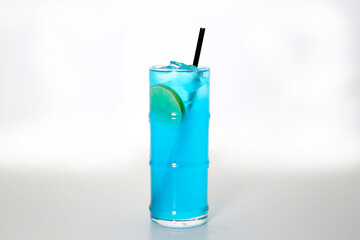Blue Hawaiian cocktail drink served in glass with straw isolated on grey background side view of healthy morning arabic drink
