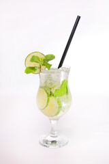 Mojito low with lime slice andd mint with straw served in glass isolated on grey background side view of healthy morning arabic drink
