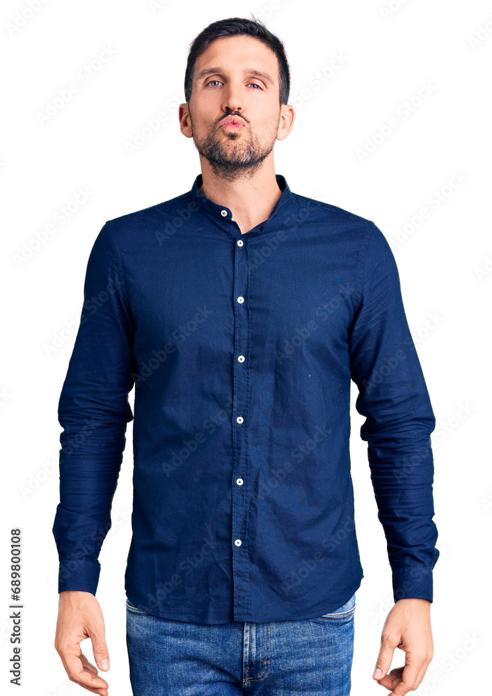 Poster Young handsome man wearing casual shirt looking at the camera blowing a kiss on air being lovely and sexy. love expression.