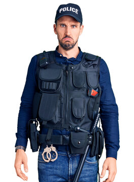 Young handsome man wearing police uniform depressed and worry for distress, crying angry and afraid. sad expression.