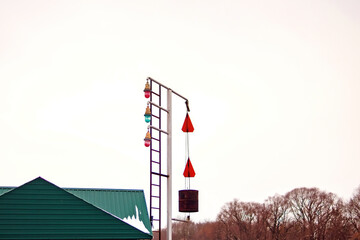 Signs and colorful lanterns at the river crossing
