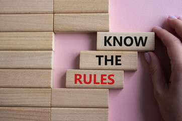 Know the rules symbol. Wooden blocks with words Know the rules. Beautiful pink background....
