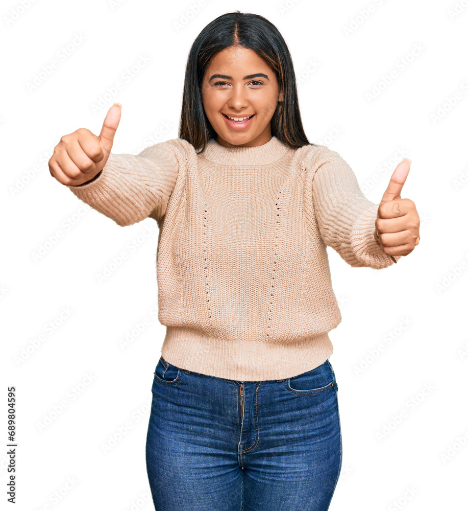 Poster Young latin girl wearing wool winter sweater approving doing positive gesture with hand, thumbs up smiling and happy for success. winner gesture.