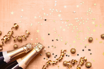 Champagne bottles and golden star confetti on peach fuzz color background. New Year, Purim concept