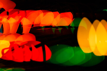 Multiple exposure vintage Christmas red, green, blue, orange and yellow lights on a black background