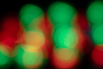 Double exposure Christmas lights, red and green. Abstract and blurred on a black background. 