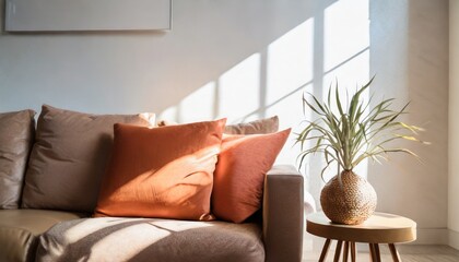 Close up of fabric sofa with terra cotta pillow against window and white wall. Scandinavian home interior design of modern living room