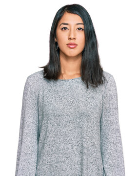 Beautiful asian young woman wearing casual clothes relaxed with serious expression on face. simple and natural looking at the camera.