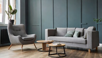 Grey chair and round coffee table near corner sofa against dark grey paneling wall. Scandinavian style home interior design of modern living room