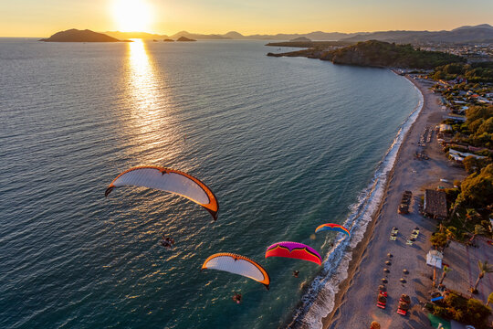Aerial view of paramotors flying in formation at Calis Beach of Fethiye, Mugla, Turkey.
