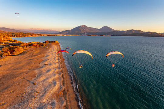Aerial view of paramotors flying in formation at Calis Beach of Fethiye, Mugla, Turkey.