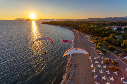 Aerial view of paramotors flying in formation at Calis Beach of Fethiye, Mugla, Turkey.