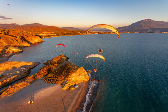 Aerial view of paramotors flying in formation at Calis Beach of Fethiye, Mugla, Turkey.