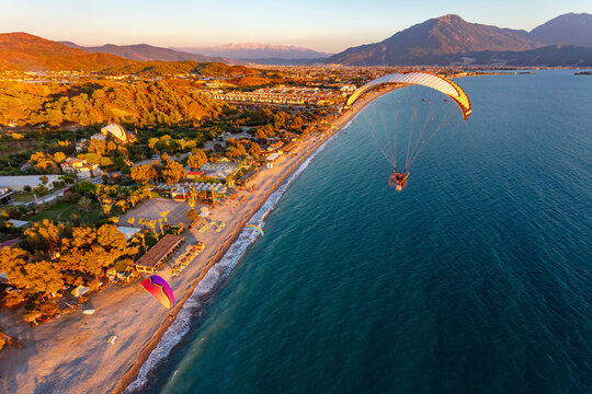 Aerial view of paramotors flying in formation at Calis Beach of Fethiye, Mugla, Turkey.