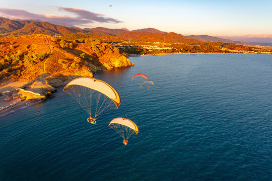 Aerial view of paramotors flying in formation at Calis Beach of Fethiye, Mugla, Turkey.