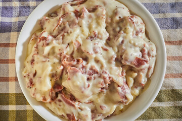 Creamed, chipped beef. A classic American dish made with preserved, salted meat.