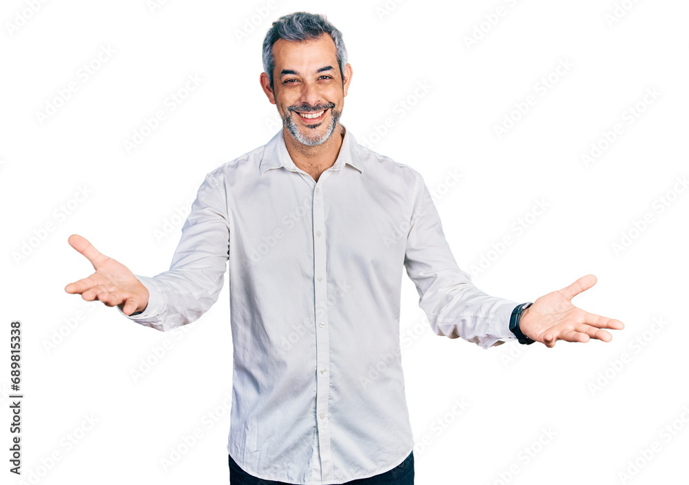 Canvas Prints Middle age hispanic with grey hair wearing casual white shirt smiling cheerful offering hands giving assistance and acceptance.