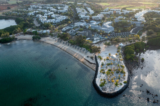 Aerial view of a luxury resort along the coastline with private beach and parasols, Opaline, Azuri Village, Rivière du Rempart, Mauritius.