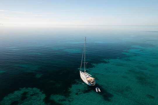 Aerial view of a sail boat on the shallow water of the Berry Islands, the Bahamas.