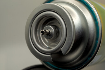 Can of gas butane on a grey closeup