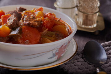 Traditional homemade beef casserole in a rustic setting.
