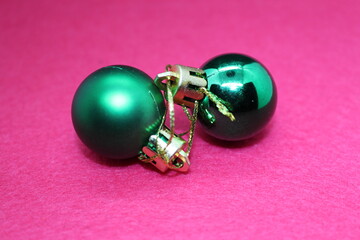 A pair of green and black goggles on a pink surface