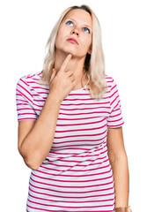 Young caucasian woman wearing casual clothes thinking concentrated about doubt with finger on chin and looking up wondering