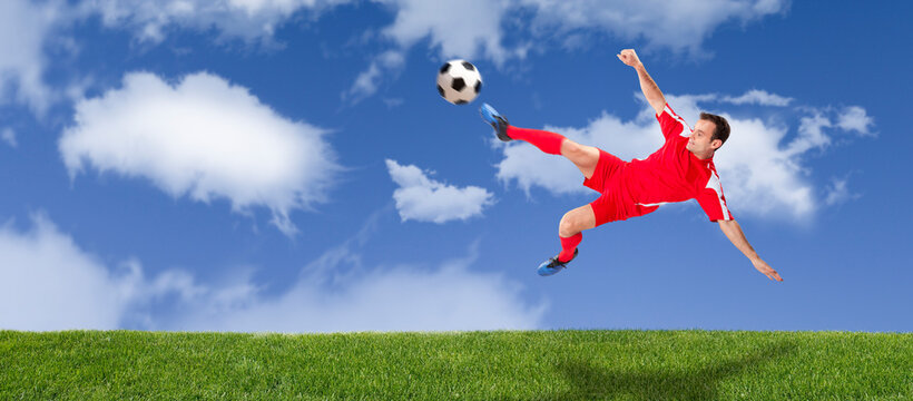 Football player kiking a soccer ball
