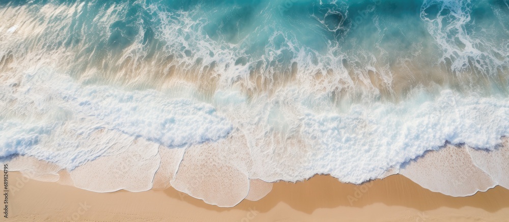 Aufkleber aerial view of ocean waves washing a secluded sandy shoreline beach. copyspace image. square banner.