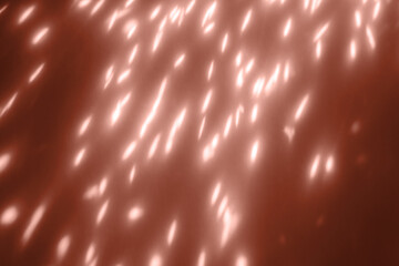 glowing sparkles closeup on dark background. Holiday background overlay In peach color of the year 2024