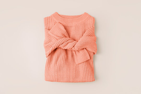 Knitted orange sweater. Peach Fuzz - color of the year 2024. Women's warm jumper, stylish autumn or winter clothes. Fashion autumnal outfit. Color trend. 