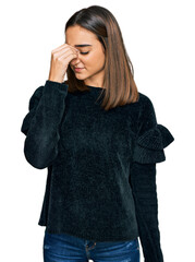 Beautiful brunette woman wearing elegant sweater tired rubbing nose and eyes feeling fatigue and headache. stress and frustration concept.