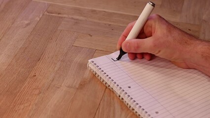 Blank notepad in class on wooden desk for mature student beginning learning lesson one. New subject for adult learning with handwritten notes and writing exercises for personal development